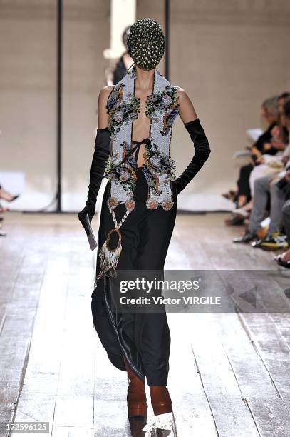 Model walks the runway during the Maison Martin Margiela show as part of Paris Fashion Week Haute-Couture Fall/Winter 2013-2014 on July 3, 2013 in...