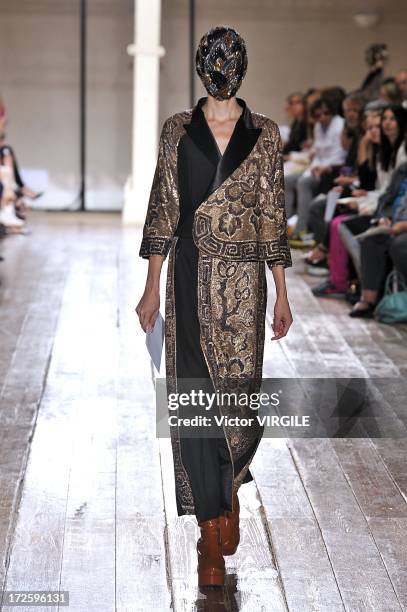 Model walks the runway during the Maison Martin Margiela show as part of Paris Fashion Week Haute-Couture Fall/Winter 2013-2014 on July 3, 2013 in...