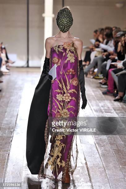 Model walks the runway during the Maison Martin Margiela show as part of Paris Fashion Week Haute-Couture Fall/Winter 2013-2014 on July 3, 2013 in...