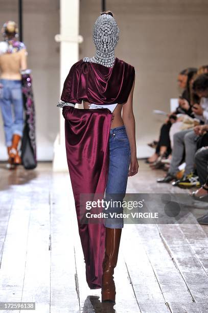 Model walks the runway during the Maison Martin Margiela show as part of Paris Fashion Week Haute-Couture Fall/Winter 2013-2014 on July 3, 2013 in...