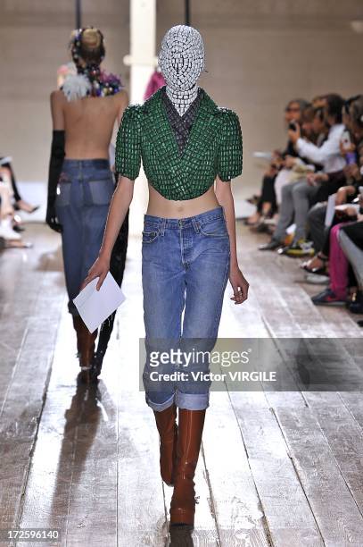 Model walks the runway during the Maison Martin Margiela show as part of Paris Fashion Week Haute-Couture Fall/Winter 2013-2014 on July 3, 2013 in...