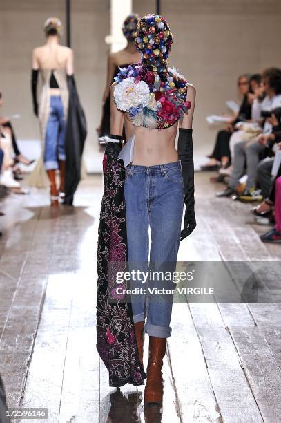 Model walks the runway during the Maison Martin Margiela show as part of Paris Fashion Week Haute-Couture Fall/Winter 2013-2014 on July 3, 2013 in...