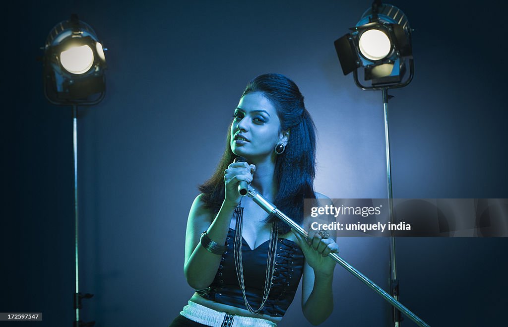 Beautiful young female singer performing on stage