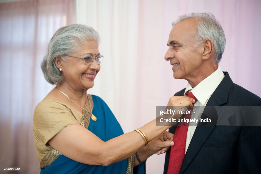 Woman adjusting the tie of her husband