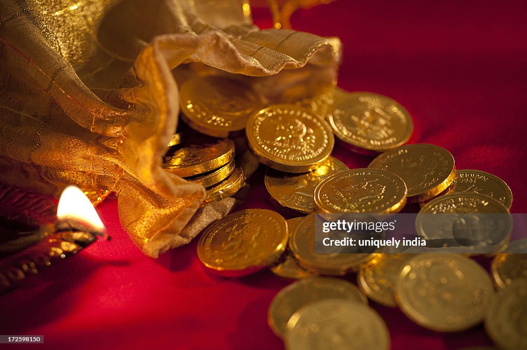 Diwali oil lamp with golden coins during Diwali festival