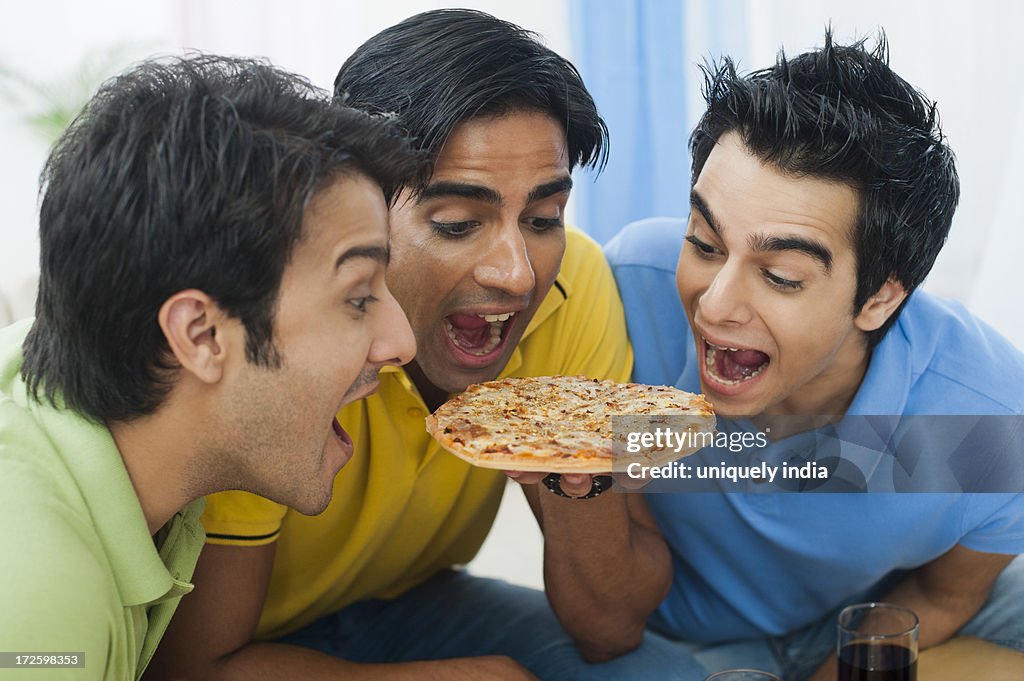 Friends sharing pizza at home