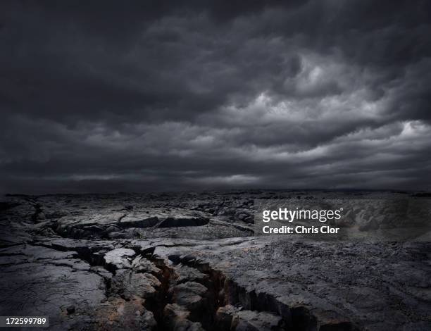 storm clouds over dry rocky landscape - volcanic landscape stock pictures, royalty-free photos & images