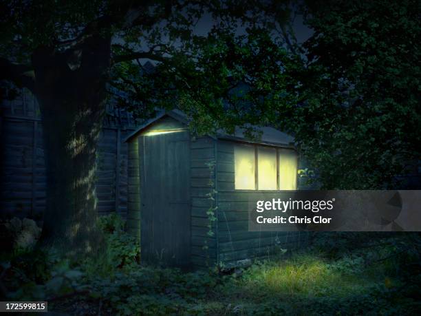 illustration of illuminated shed in garden - shed stock illustrations