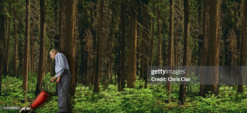 Caucasian man vacuuming forest floor