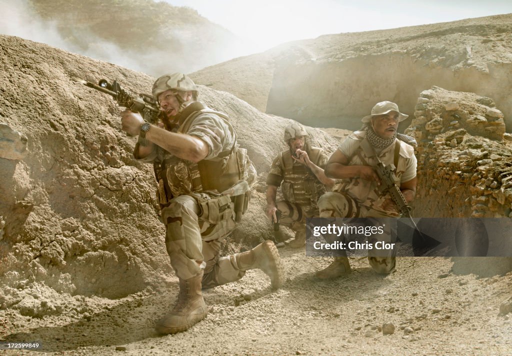 Soldiers advancing in dry rural landscape