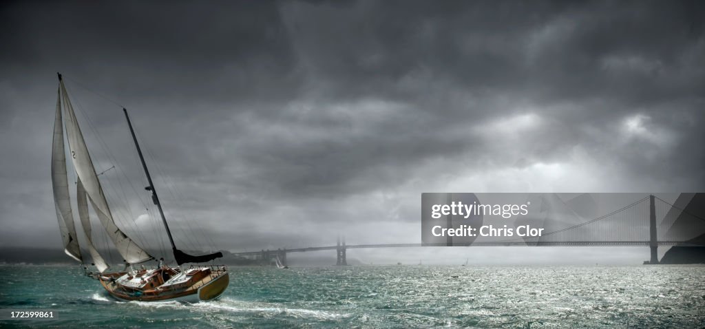 Boat tipping in urban bay, San Francisco, California, United States
