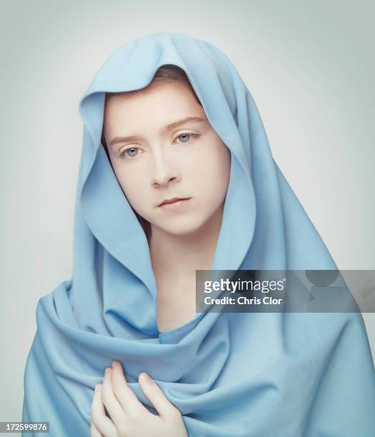 caucasian girl wrapped in blanket - jungfrau maria stock-fotos und bilder