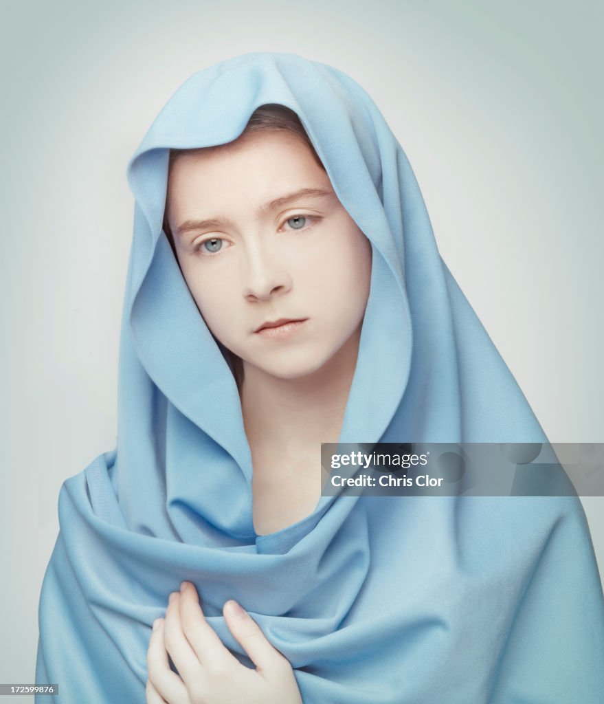 Caucasian girl wrapped in blanket