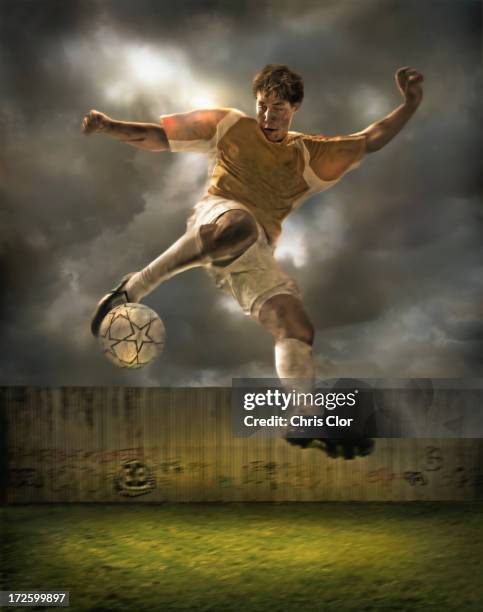 illustration of soccer player kicking ball in field - joe allen welsh soccer player stock illustrations