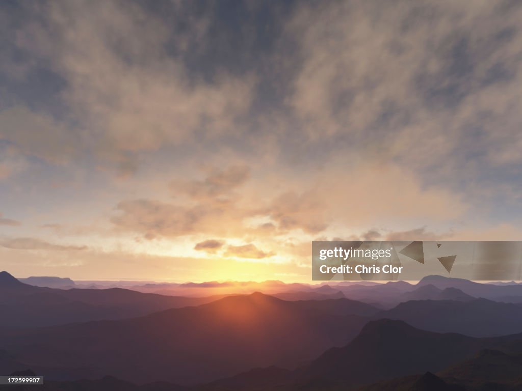 Sun rising over rural mountains