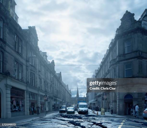 cars driving on cracked urban pavement - inverness stock pictures, royalty-free photos & images