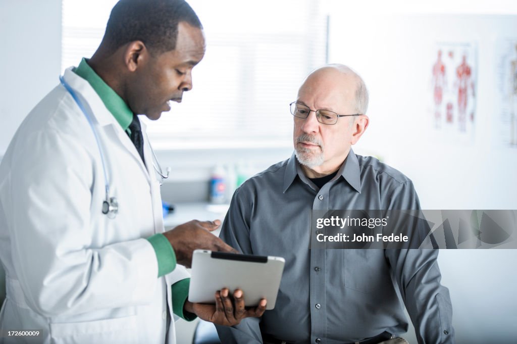 African American doctor talking to patient in office