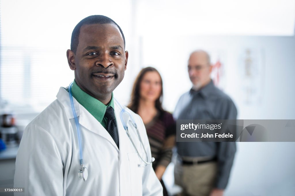 Doctor and patients standing in office