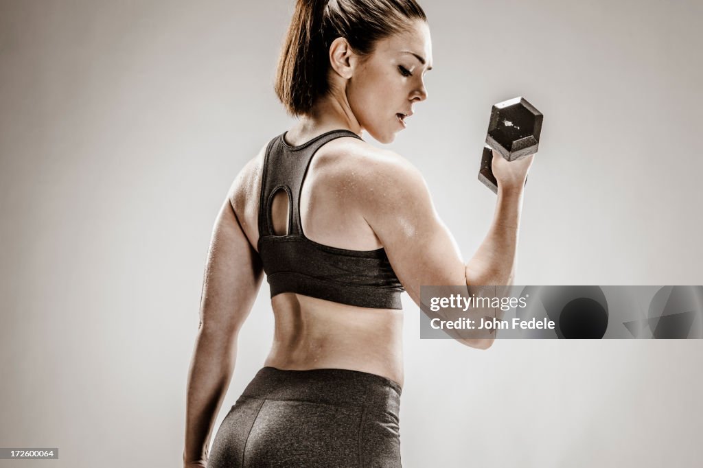 Caucasian woman lifting weights