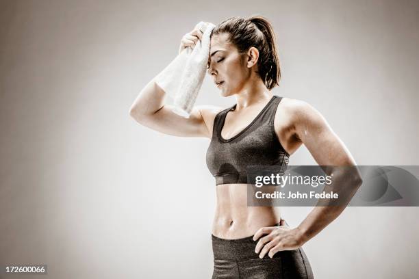 caucasian woman wiping sweat from forehead - sweaty arm stock pictures, royalty-free photos & images