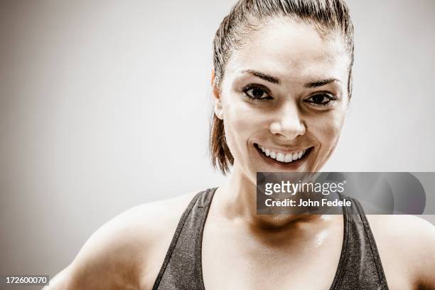 smiling caucasian woman sweating during workout - john hale stock pictures, royalty-free photos & images