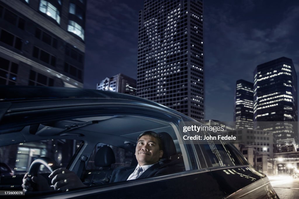 Pacific Islander businessman driving on city street