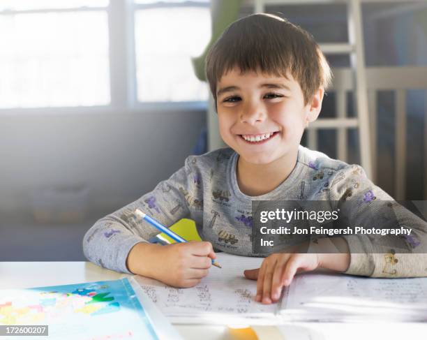 hispanic boy doing homework at desk - germantown maryland stock pictures, royalty-free photos & images