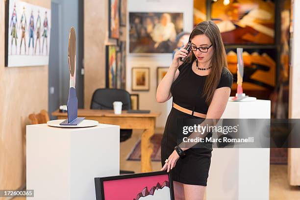 caucasian woman working in art gallery - art gallery owner stock pictures, royalty-free photos & images