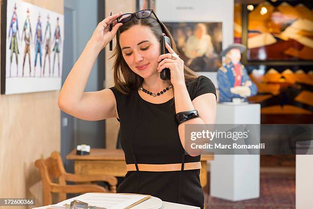 caucasian woman working in art gallery - art gallery owner stock pictures, royalty-free photos & images