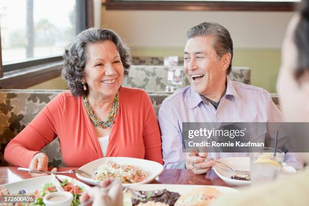 older hispanic couple having dinner in restaurant - smiling woman on gray background 50 stock pictures, royalty-free photos & images