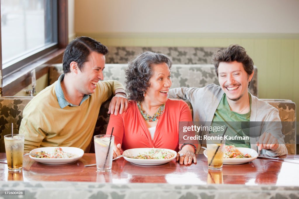 Hispanic family having dinner in restaurant