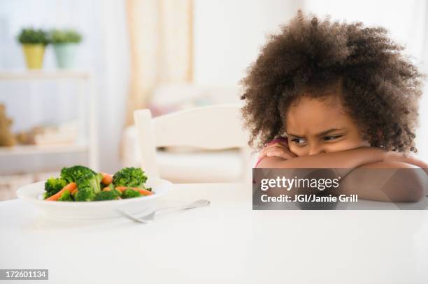 african american girl refusing vegetables at table - refusing fotografías e imágenes de stock