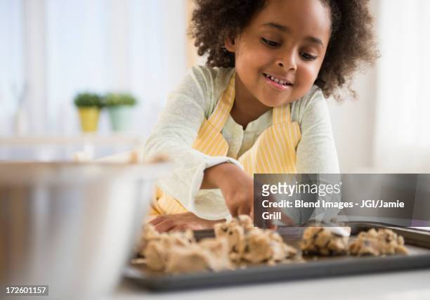african american girl baking cookies in kitchen - gluren stock pictures, royalty-free photos & images