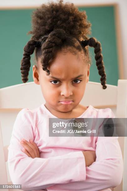 african american girl frowning in classroom - girl arms crossed stock pictures, royalty-free photos & images