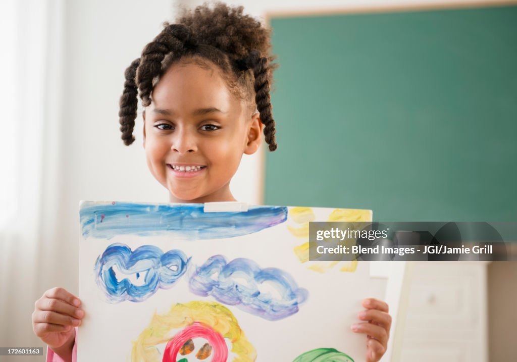 African American girl with painting in classroom