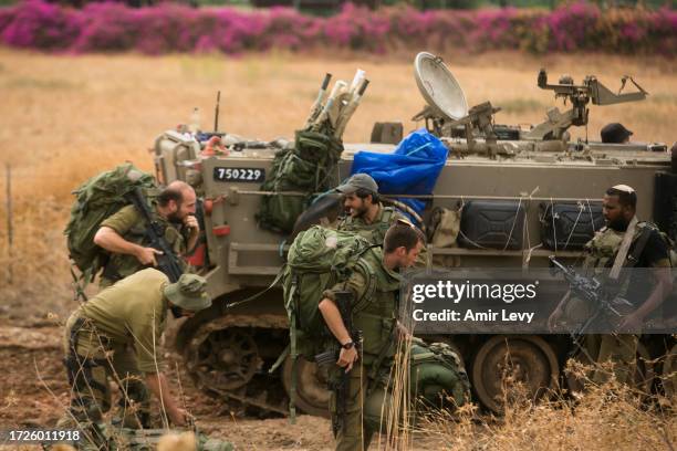 Israeli soldiers organize their armor personnel carriers as they are move in formation near the Israeli border with Lebanon on October 15, 2023 Near...