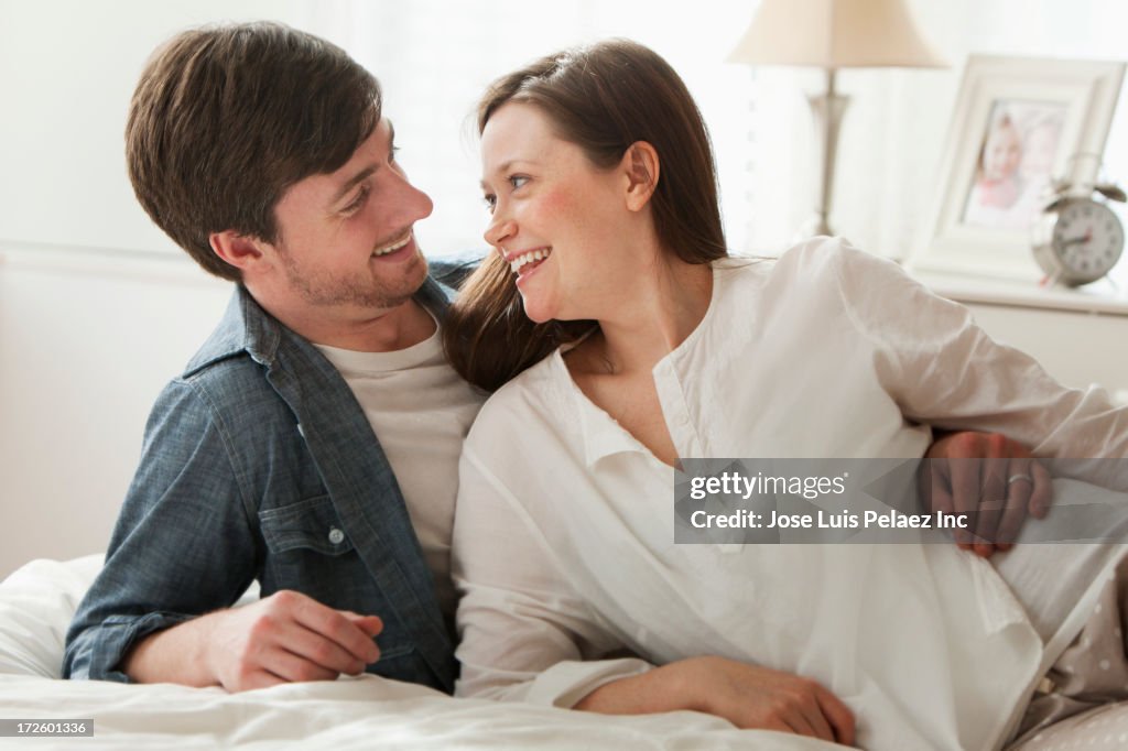Caucasian couple laying on bed
