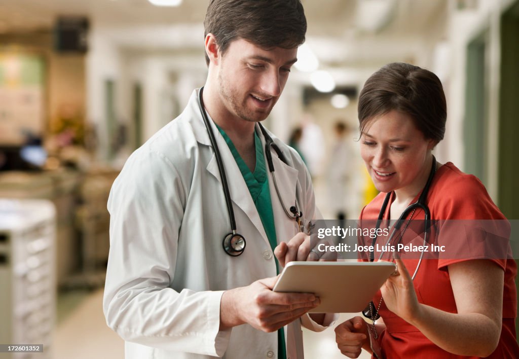 Caucasian doctor and nurse using tablet computer