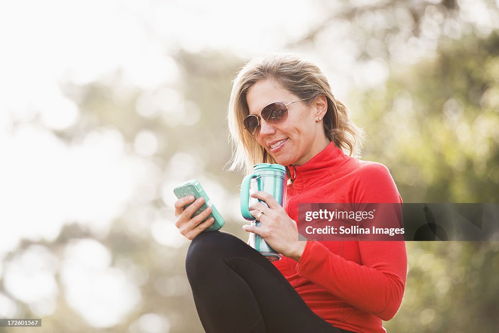 Caucasian woman using cell phone outdoors