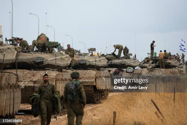 Israeli soldiers organize their armor personnel carriers as they are moving in formation near the Israeli border with Lebanon on October 15, 2023...