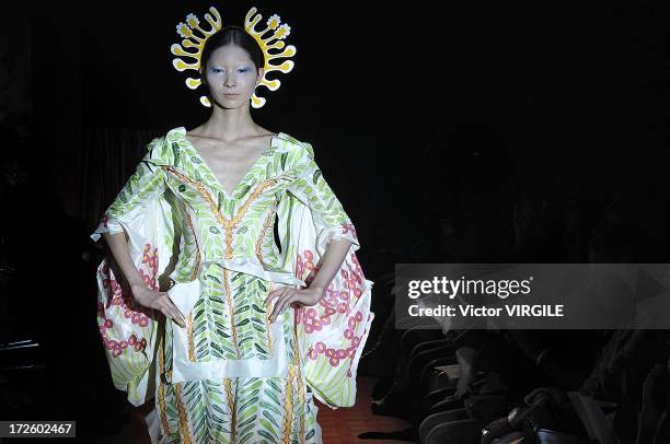 Model walks the runway during the Yoshiki Hishinuma Couture show as part of Paris Fashion Week Haute-Couture Fall/Winter 2013-2014 at the Hotel...