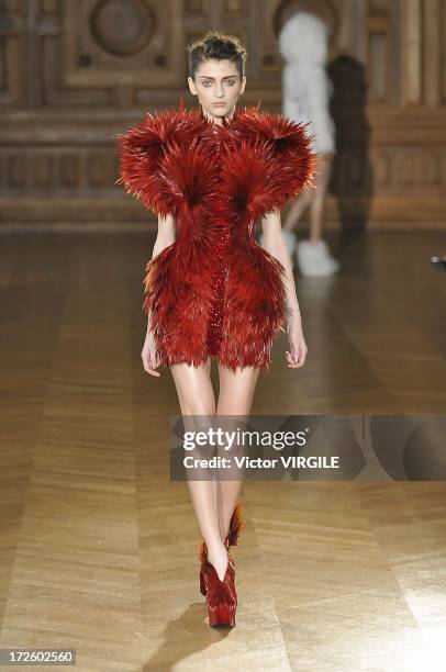 Model walks the runway during the Serkan Cura Couture show as part of Paris Fashion Week Haute-Couture Fall/Winter 2013-2014 at the Mairie du 4e on...