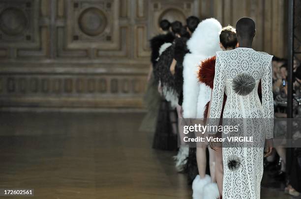 Model walks the runway during the Serkan Cura Couture show as part of Paris Fashion Week Haute-Couture Fall/Winter 2013-2014 at the Mairie du 4e on...