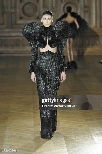 Model walks the runway during the Serkan Cura Couture show as part of Paris Fashion Week Haute-Couture Fall/Winter 2013-2014 at the Mairie du 4e on...