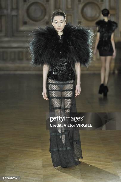 Model walks the runway during the Serkan Cura Couture show as part of Paris Fashion Week Haute-Couture Fall/Winter 2013-2014 at the Mairie du 4e on...