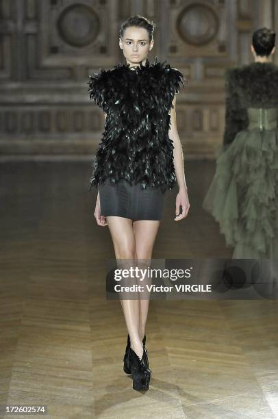 Model walks the runway during the Serkan Cura Couture show as part of Paris Fashion Week Haute-Couture Fall/Winter 2013-2014 at the Mairie du 4e on...