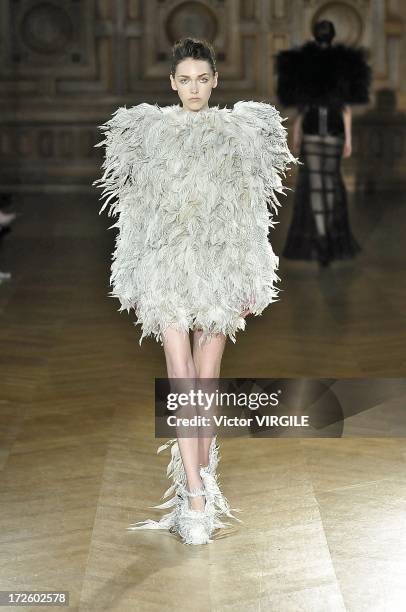 Model walks the runway during the Serkan Cura Couture show as part of Paris Fashion Week Haute-Couture Fall/Winter 2013-2014 at the Mairie du 4e on...