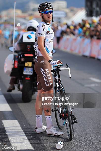Maxime Bouet of France riding for Ag2r La Mondiale waits for a bike change after being involved in a crash in the last kilometer during stage five of...