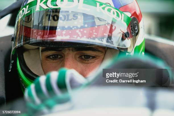 Dario Franchitti from Scotland adjust his driving gloves as he sits aboard the Team Green Reynard O1i Honda HR1 during practice the Championship Auto...