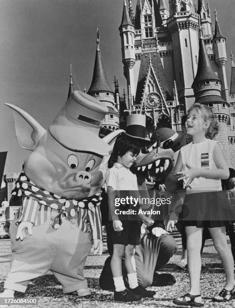 Disney characters with the Cinderella Castle in the background as children visit Disney World in Orlando, Florida, 3rd January 1973. The characters...